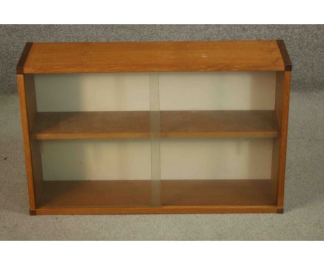 A vintage teak wall hanging cupboard with glass sliding doors. H.51 W.81 D.22cm. 