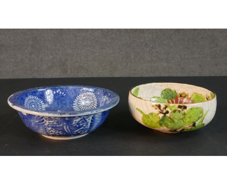 Two Japanese hand painted ceramic bowls. One blue and white stylised floral design bowl and an orange and yellow chrysanthemu