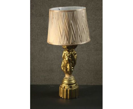 A classical style table lamp, the moulded gilt painted stem in the form of The Three Graces, with a shade. H.59 Dia.31cm. 