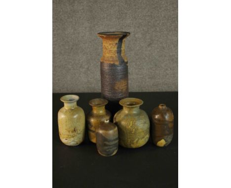 A collection of six brown and green marbled glaze stoneware pots. Impressed M mark to the base of four. H.33 W.10cm.(largest)