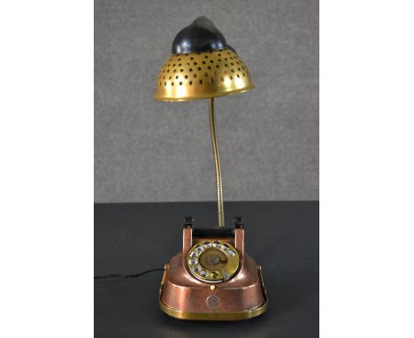 A vintage copper dial up telephone converted into a novelty desk lamp. H.40 W.48cm 
