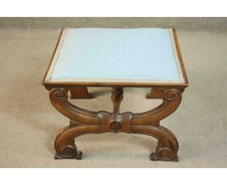 A late 19th century French walnut footstool, of square form upholstered in light blue fabric, on carved, curved, scrolling X 