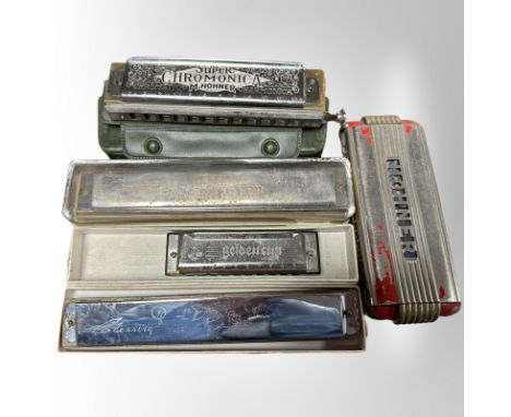 A collection of mouth organs including Hohner.
