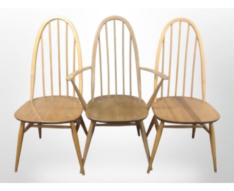 A pair of Ercol elm and beech spindle back dining chairs and a similar carver armchair. CONDITION REPORT: Armchair with split