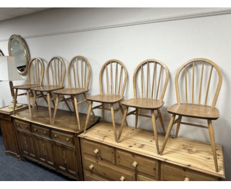 A set of six Ercol elm and beech spindle back dining chairs.