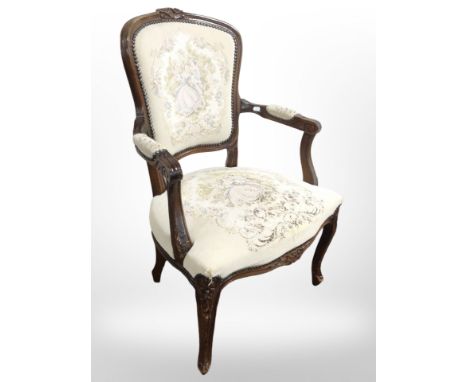 A continental carved salon armchair in tapestry fabric, width 62cm.