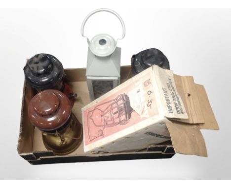 A Tilley storm light, in box, and three further oil lamps and a modern lantern. (1 box)