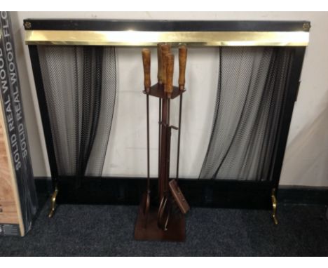 A mesh firescreen, width 97cm, together with a companion set on stand.