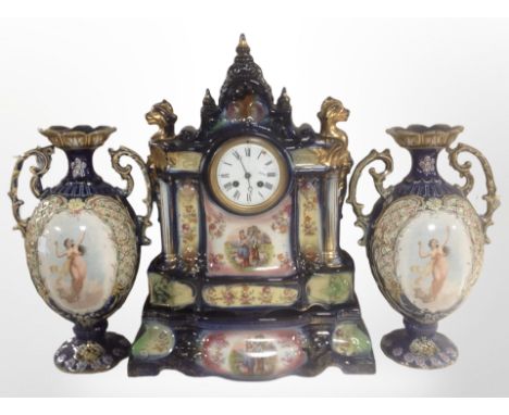A late-Victorian transfer-printed ceramic three-piece clock garniture, height 52cm. CONDITION REPORT: Urns with restorations.