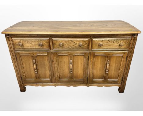 An Ercol stained-elm sideboard, 143cm wide x 53cm deep x 85cm high.