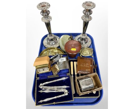 A group of metal wares including pair of ornate silver-plated candlesticks, cutlery, nutcrackers, hip flask, Ronson lighter, 