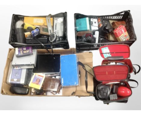 A collection of photography-related items including cameras, accessories, Yashica Super 8 video camera, other items including