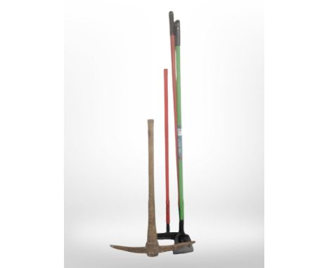 A vintage pickaxe and three further modern garden tools.