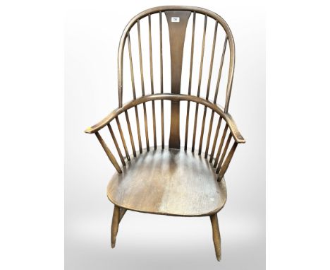 An Ercol stained-elm and beech spindle back armchair, width 60cm.
