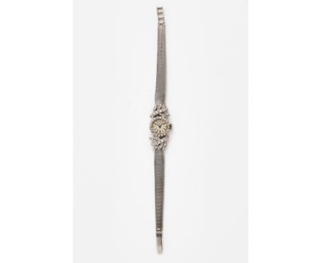 Kl. Damenarmbanduhr Fa. Curtis,Schweiz 1960/70er Jahre. 18 kt WG. Handaufzug. Gehäuse-Nr. 103725. Lünette u. florale Bandansä