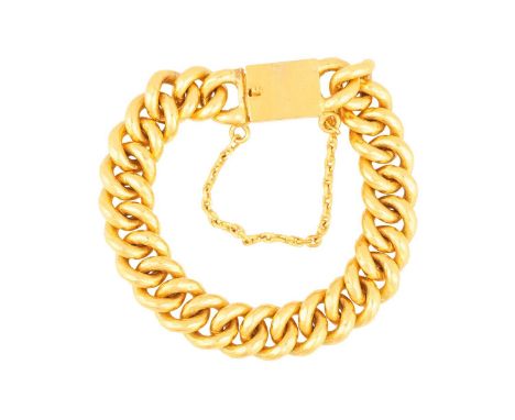 A heavy curb link bracelet, completed with a box clasp, push-in thumbpiece and safety chain, Chinese marks for 'pure gold' an