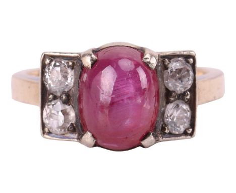 A star ruby and diamond dress ring, centred with an oval star ruby of 8.3 x 6.5 x 5.8 mm, claw-set between geometrical should