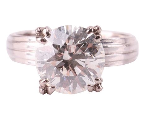 A diamond solitaire ring, featuring a round brilliant diamond, measuring approximately 8.2mm, with an estimated carat weight 