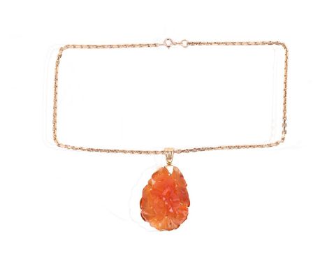 A carved carnelian pendant on chain, the large carnelian depicting a rabbit amidst blooming flowers and peaches, to a foliate