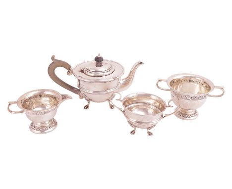 A bachelor teapot and matching sugar basin; circular with a reeded band to the girdle, on four shell mounted pad feet, with f