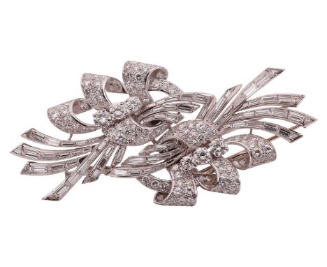 A mid-20th century diamond-set double clip/brooch, of scrolling design, channel-set with baguette-cut diamonds, overlaid with