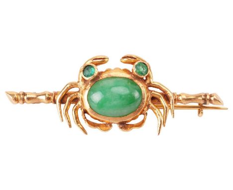 A jade crab bar brooch, centred with a crab motif with an oval jadeite cabochon and green paste as eyes, on a bamboo mount an