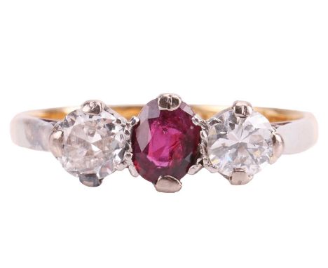 A ruby and diamond trilogy ring, centred with an oval-cut ruby of 5.7 x 4.1 x 2.1 mm, set between two old-cut diamonds with a