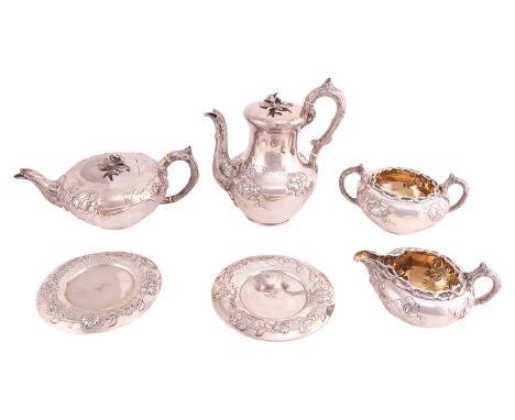 A William IV four-piece silver tea service, the teapot and coffee pot with bird and flower cast finials, the bark handles wit