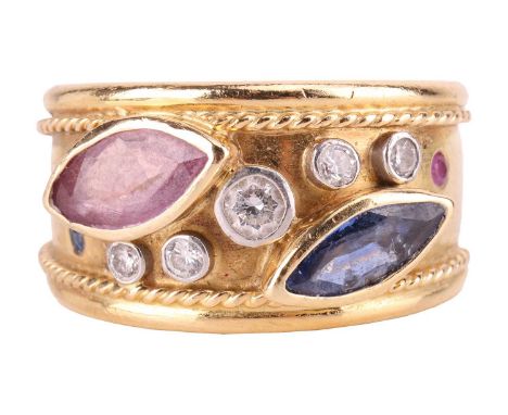 A gem-set dress ring in Etruscan design, set with a marquise-cut sapphire and a ruby, embellished with graduated brilliant-cu