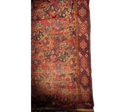 A LARGE TURKISH CARPET FRAGMENT with typical geometric and stylised foliate decoration in tones of indigo, madder and green, 