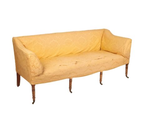 A GEORGE III MAHOGANY AND UPHOLSTERED SOFA, Circa 1800, with straight horizontal back and sides broadening to the seat, on fo