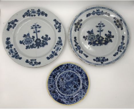 A DUTCH DELFTWARE BLUE AND WHITE CHARGER decorated with sprays of flowers within a geometric outer border, 34.5cm dia., a sim