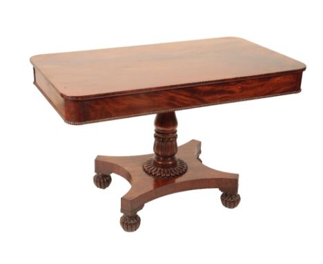 A GEORGE IV MAHOGANY SOFA TABLE, Circa 1825, the single piece figured top with rounded corners, a drawer at each end, on a ba