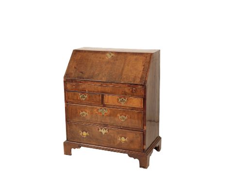 A GEORGE II WALNUT BUREAU, Basically mid 18th century, with crossbanded top and fall front, opening to a fully fitted interio
