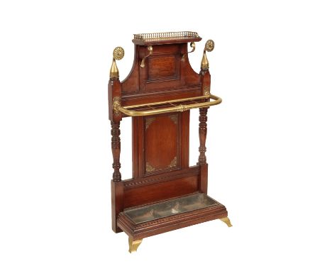 AN AESTHETIC MOVEMENT OAK AND BRASS STICK STAND BY JAMES SHOOLBRED, Circa 1875, the upper shelf with brass three quarter balu