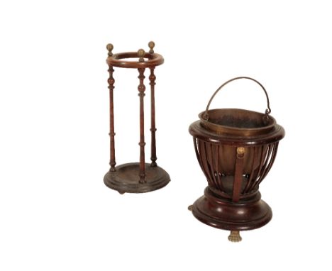 A VICTORIAN MAHOGANY, BRASS AND CAST IRON MOUNTED STICK STAND, The circular top with moulded edge beneath three spherical fin