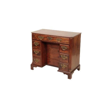 A GEORGE III MAHOGANY KNEEHOLE DESK, Circa 1770 and later elements, the top with canted front corners, above an arrangement o