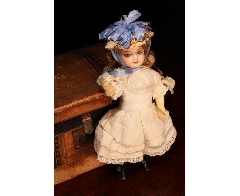A late 19th century French bisque head Bébé doll, of small proportions, the bisque head with inset fixed blue glass eyes, pai