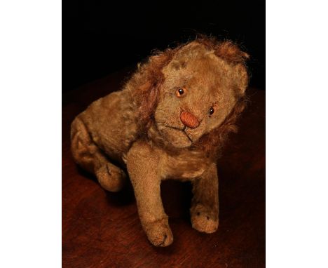 An early 20th century jointed golden mohair Lion, attributed to Steiff (Germany), amber and black glass eyes, pink stitched n