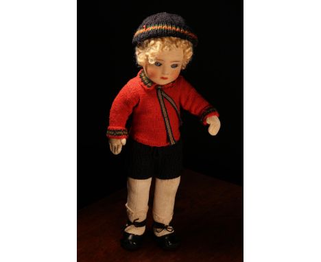 A 1920's Chad Valley doll, the moulded felt face with painted features and inset blue glass eyes, blonde wig, jointed velvet 