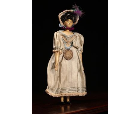 A 19th century painted papier-mâché or gesso head doll, the painted papier-mâché or gesso head with painted features includin