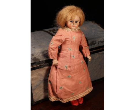A bisque shoulder head doll, the bisque shoulder head inset with fixed blue glass eyes, painted features including brown eyeb