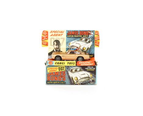 A Corgi Toys James Bond Aston Martin (261). An early example in gold with James Bond and passenger figures. Boxed with inner 