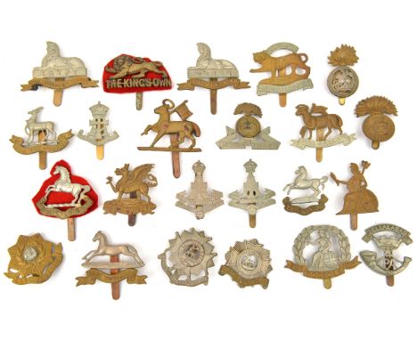 23 different infantry cap badges, including Queens with and without title, KORR, Northumberland Fus brass and bi-metal, Kings