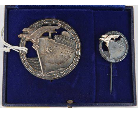 A Third Reich Blockade Breaker’s badge,  by Schwerin, Berlin (the hinge incorrectly applied), with its miniature stick pin, i