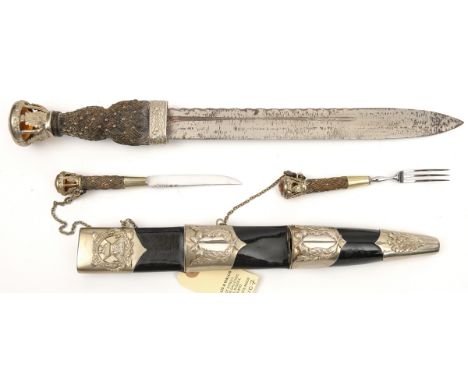 A commemorative dirk of The Seaforth Highlanders, blade 11”, studded strap work hilt, open work pommel set with glass “citrin