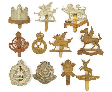 7 Territorial Regt cap badges: 1st Bn Monmouth 1st patt WM and brass, 2nd patt WM, 2nd Bn (1777), Hereford bi-metal (1794), H