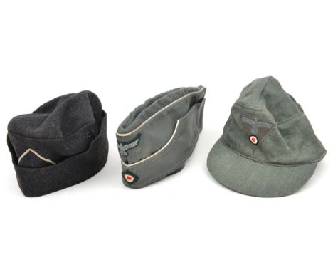 A Third Reich style olive green soft peaked cap, with one piece army eagle and cockade on triangular patch; an olive green of