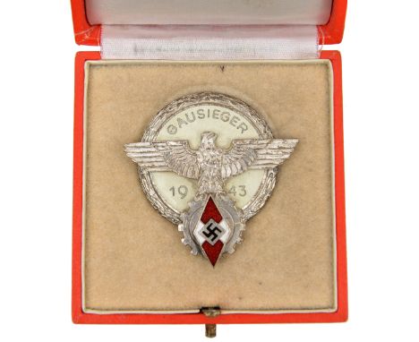 A Third Reich Hitler Youth Gausieger badge,  dated 1943, in silver plate and enamel, by “A G Tham Gablonz a N”, in its fitted