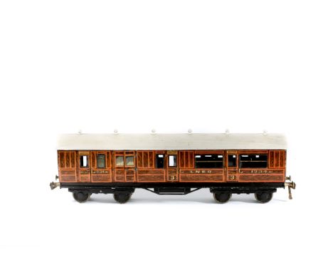 A Gauge One Railway 1920s Bing for Bassett-Lowke tinplate LNER brake 3rd bogie coach. An example in teak finish with white ro